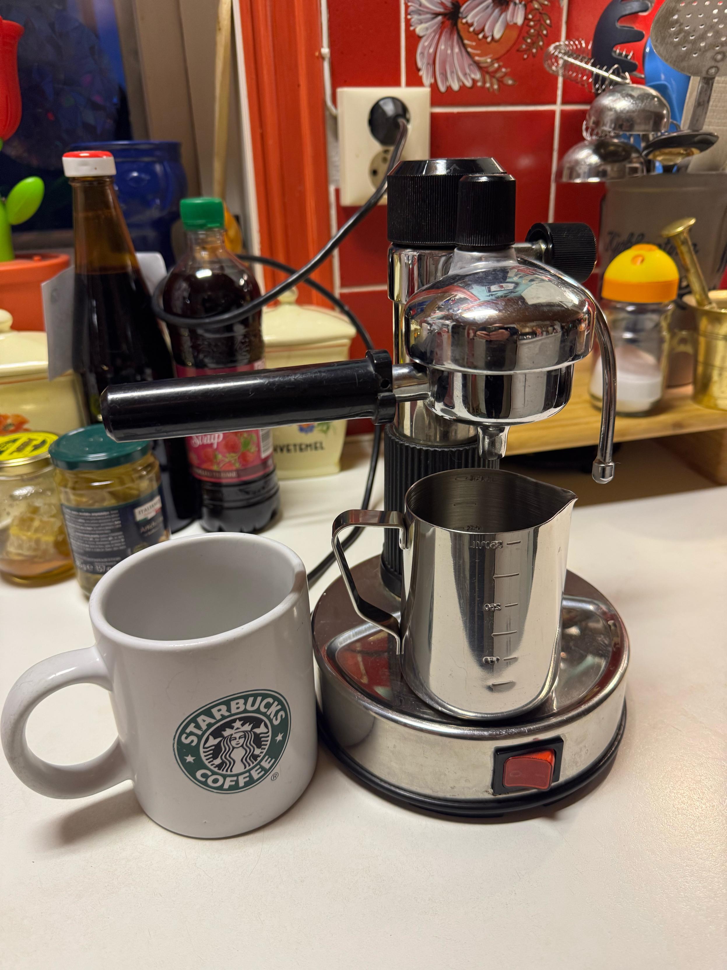 Chrome coffee brewer and star bucks mug
