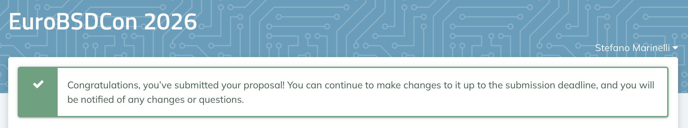 Screenshot of the EuroBSDCon 2026 submission system showing a green confirmation banner with a checkmark: "Congratulations, you've submitted your proposal! You can continue to make changes to it up to the submission deadline, and you will be notified of any changes or questions." The page header reads "EuroBSDCon 2026" over a teal circuit-board pattern, with the name Stefano Marinelli in the top right.